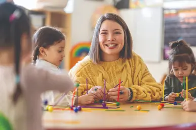 Teacher playing with her students
